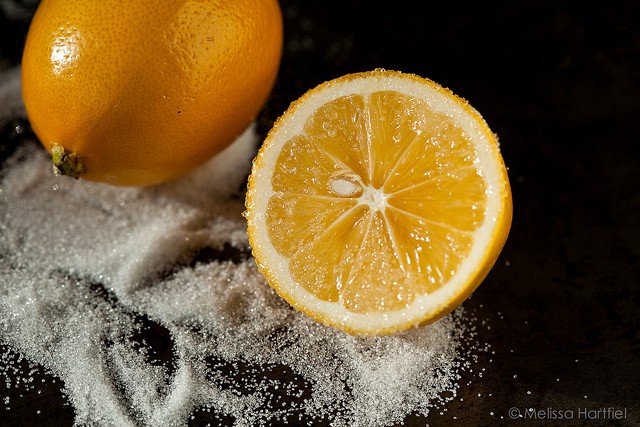 Cut in half lemon in a pile of sugar